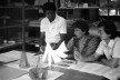 Professores Cirineu de Almeida (arquiteto), Sáida Cunha (pintora), e Tai Hsuan-An (arquiteto e pintor) avaliando trabalhos dos alunos na Escola de Artes e Arquitetura da PUC-Go, década de 1980