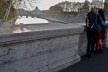 Contaminações, turistas na Ponte Umberto I sobre o rio Tevere com vistas para a Cidade do Vaticano
