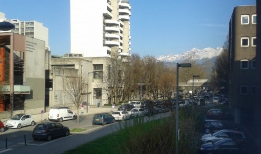 À esquerda, a École de Architecture; ao fundo, coberto de neve, os Alpes, foto do primeiro dia em Grenoble