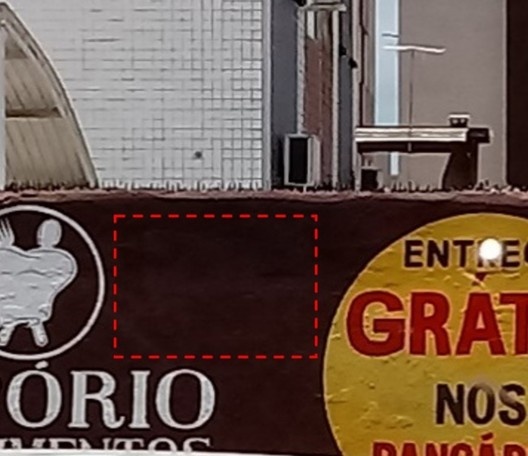 Lambe-lambe coberto por tinta, com área destacada em vermelho