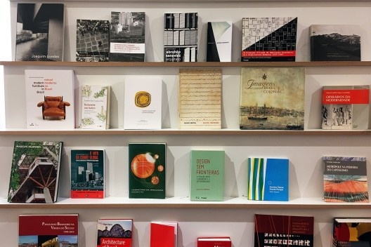 Exposição FAU 70 anos, estante com livros de autoria de professores da escola