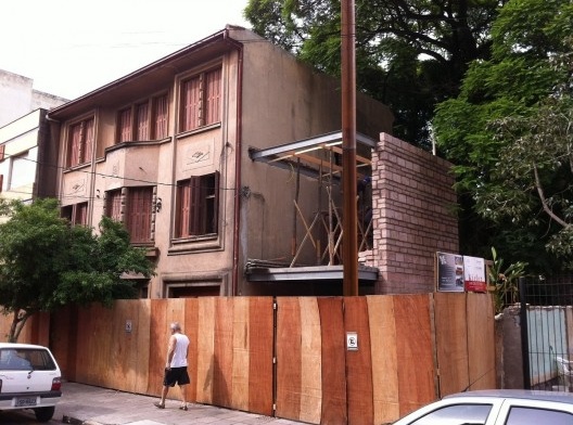 Detalhe da obra, mostrando estrutura metálica apoiada na parede lateral, alvenaria de pedras e pilar metálico em forma de “L”