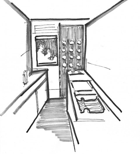 La cocina que utiliza dos paneles distintos como cerramiento. El con aberturas circulares para la pieza técnica (horno) y el con la ventana guillotina para la permanencia de una persona que cocina